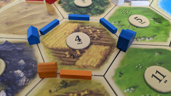 How to play Catan - photo of buildings from Settlers of Catan
