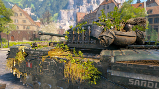 World of Tanks best tanks guide - wargaming WoT screenshot showing a D-day event tank with foliage camouflage moving through a village