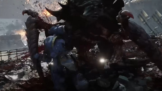 Space Marine 2 enemies - screenshot of Lt. Titus punching a colossal Carnifex, a massive crablike creature bristling with claws and blade limbs