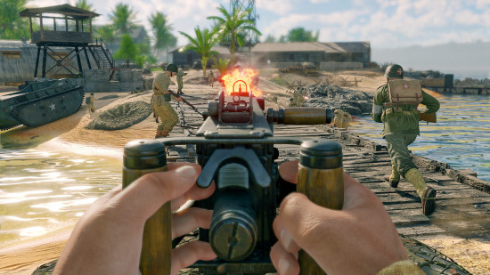 Best free war games online guide - Enlisted screenshot showing the player firing a machine gun while AI comrades storm an island during a WW2 pacific battle