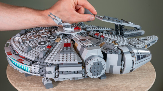 Lego Star Wars: Millennium Falcon review image showing the side of the ship with a person's hand on the roof.