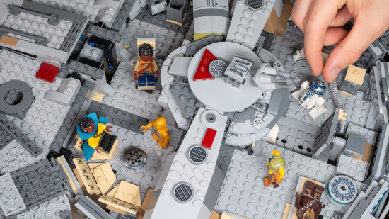 Lego Star Wars: Millennium Falcon review image showing the top of the ship open with someone adjusting the minifigures inside.