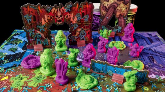 Necromolds review - green and purple clay monsters from the starter set battle it out across a cardboard board