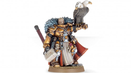 Warhammer 40k Inquisition - Inquisitor Coteaz, wearing golden armor, holding a hammer and a two-headed eagle