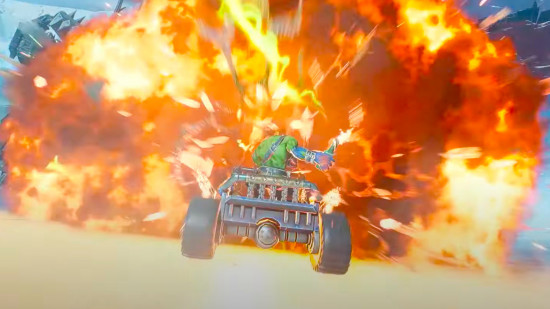 Warhammer 40k Speed Freeks screenshot, an Ork riding in the back of a buggy rides into a fireball