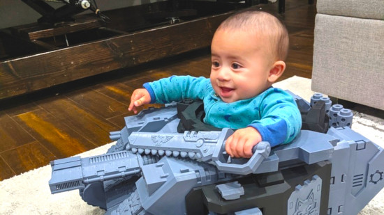 Baby Azrael in the Land Raider Tank holding a chainsword.