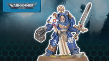 A Warhammer 40k Space Marine Terminator captain in blue armor, wielding a twin-barrelled boltgun and a power sword