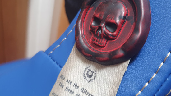 The novelty red purity seal stuck on the Warhammer 40k Ultramarines gaming chair
